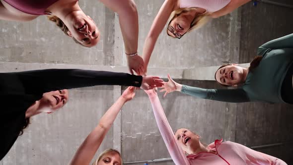 Group or Team of Happy Young Sportive Women in a Gym All Cheering with Hands Up and Applauding