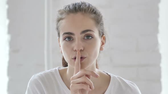 Finger on Lips Silence Gesture By Young Girl