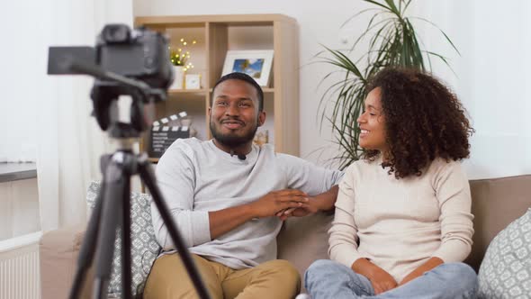 Couple of Video Bloggers with Camera at Home