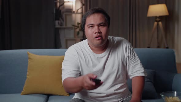 Asian Fat Male With Tv Remote Pressing Button And Changing, Switch Channels