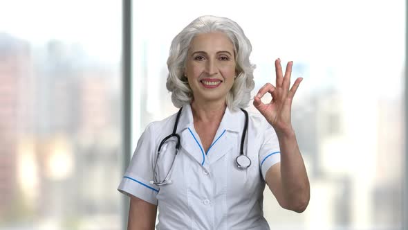 Senior Woman Doctor Showing OK Sign.
