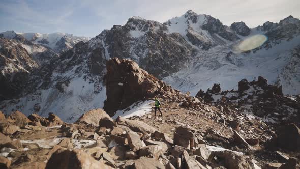 Man Running at the Mountain with Snow