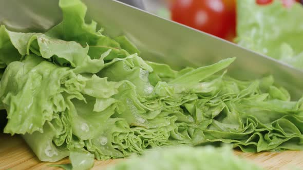 Chef Cuts the Salad Leaves with a Knife in Slow Motion Making a Salad Fresh Vegetables on a Cutting