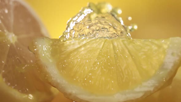 Slow Motion Shot of Lemon Juice Splashing Through Lemon Slices