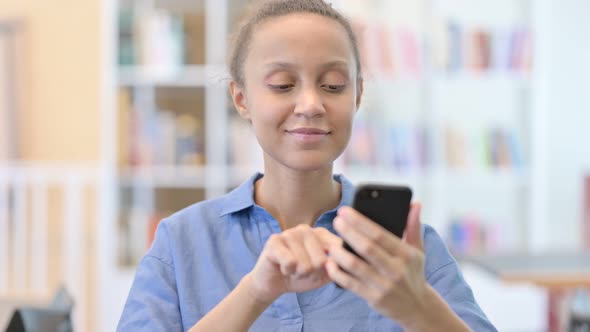 Portrait of Attractive African Woman Using Smartphone