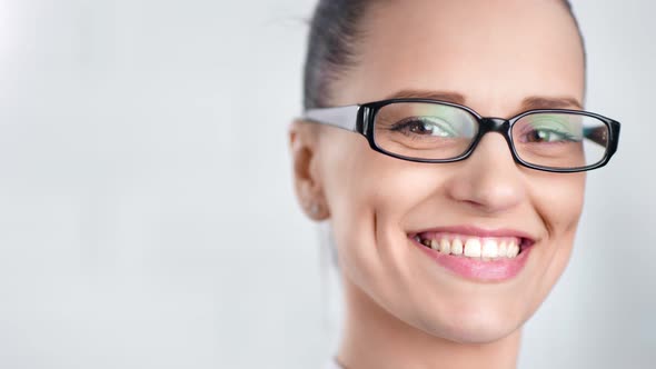 Closeup Face of Smiling Beautiful Business Woman Wearing Glasses Isolated at White Studio