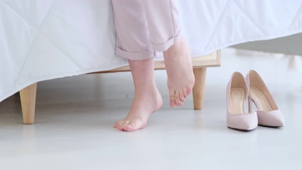 Beautiful Young Business Woman Taking Her Shoes Off After a Long Day