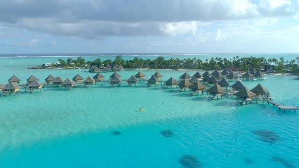 Aerial drone view of a man and woman couple on a tandem sea kayak in Bora Bora tropical island