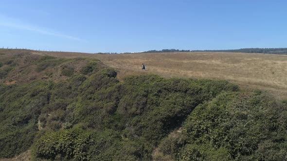 Lone Person Walking In The Vast Scenery Of A Countryside In South Chile, South America. Wide Aerial