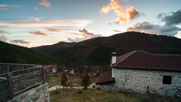 Fast moving clouds over the mountain slopes at sunrise