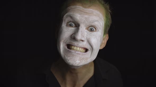 Clown Halloween Man Portrait, Close-up of an Evil Clowns Face, White Face Makeup