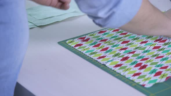 Hands arranging a colorful fabric