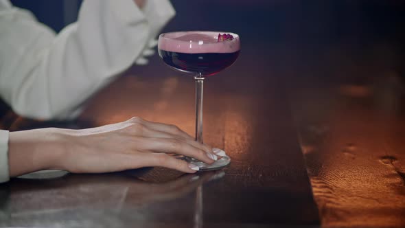 Woman with a Beautiful Manicure Sits in a Bar or Restaurant