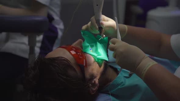 Woman Dentist Treats a Man