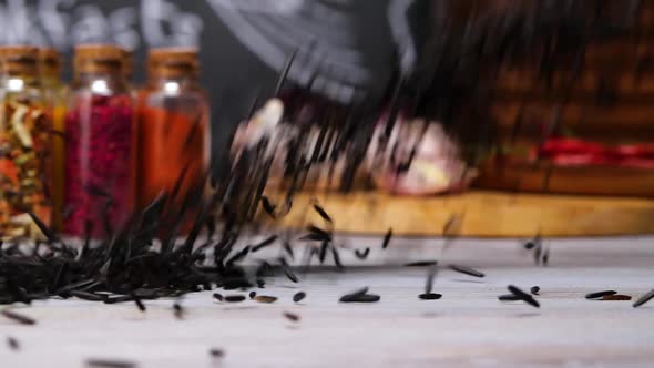 Black Cumin Seeds Falling on Table