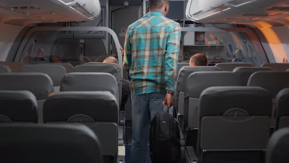 Diverse Passengers Boarding on Airplane to Fly in Economy Class