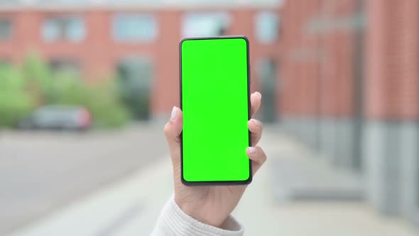 Woman Holding Smartphone with Green Chroma Screen
