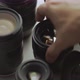 A hand picking down the lens of the camera between another lens - VideoHive Item for Sale