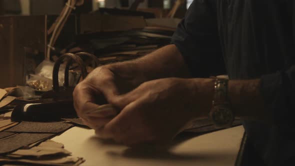 Clip of a craftsman working on a bag in Italy.