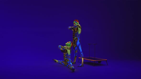 Twins Acrobats Perform A Pair Trick, Guys In Luminous Ultraviolet Suits With Bright Color Makeup 