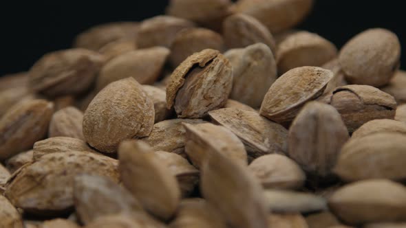 Pile Of Almonds In Shell On A Wooden Table