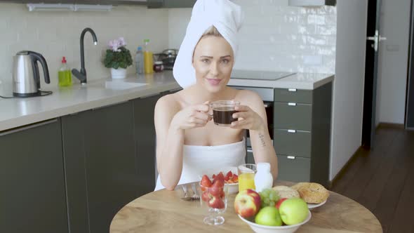 Beautiful Woman with Towel on Head Having a Healthy Breakfast and Coffee