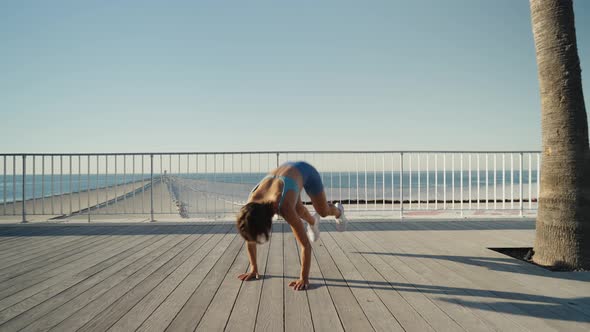 Sportswoman Workout Outdoor on Seaside  She Make Burpee Exercise