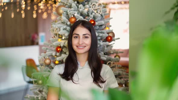 Beautiful Smiling Mixed Race Woman Pretty Face on Background Christmas Tree