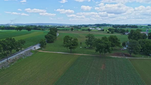 Aerial View of the Farm Countryside With Planted Fields and a Single Rail Road Track