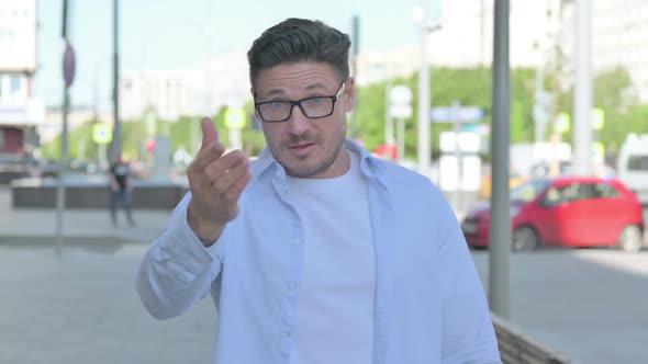 Man Pointing at the Camera and Inviting Outdoor