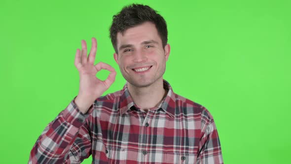 Portrait of Young Man Showing Okay Sign Green Chroma Screen