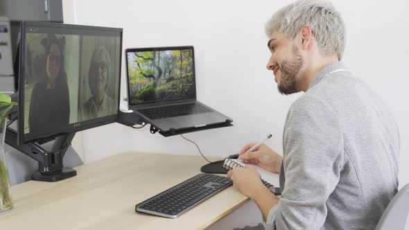 Young Hipster Man Doing Video Call Meeting with His Colleagues