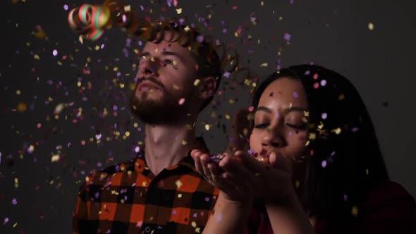 Group of friends start a party with confetti and streamers and start dancing with euphoria - Slow mo