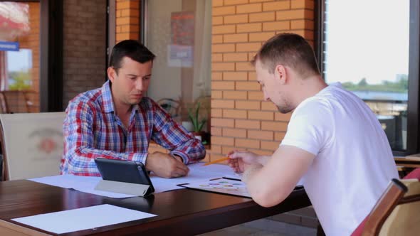 A meeting of two civil engineers to discuss the construction of a business center.