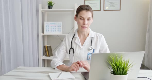 Doctor Talking To Patient Using Virtual Chat Computer App. Female Medical Therapist Wears Medical