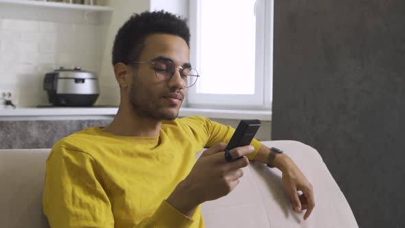 Africanamerican Young Man Watching Tv at Home