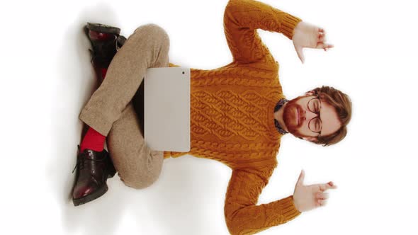 Stylish Man Sitting with His Laptop and Crossing His Fingers Wishing the Good Luck to the Internet