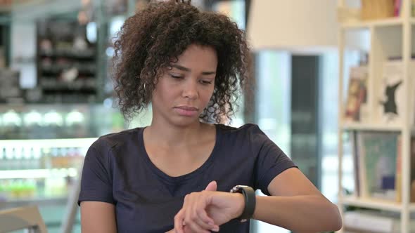 Portrait of Serious Young African Girl Using Smart Watch