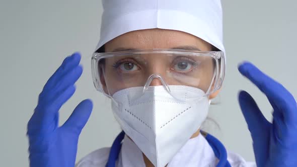 Female Doctor is Putting Off Protective Blue Gloves Isolated on White Background After Some Medical