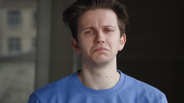 Caucasian Guy Millennial Sad Student Young Man Isolated Indoors at Home Looking at Camera Waving