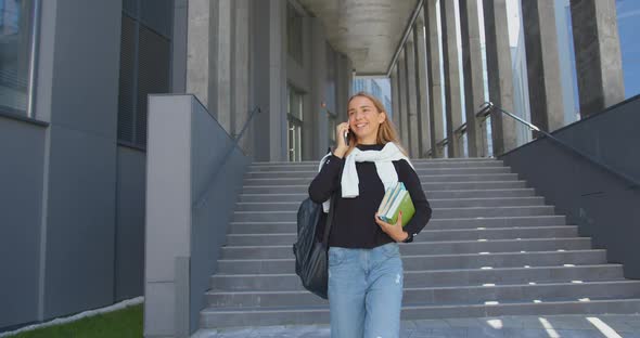 Girl-Student in Casual Clothes Going Down the Steps while Leaving University