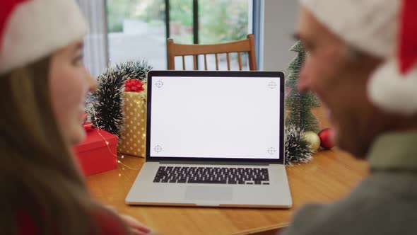 Caucasian senior father and adult daughter making video call on laptop with copy space on screen