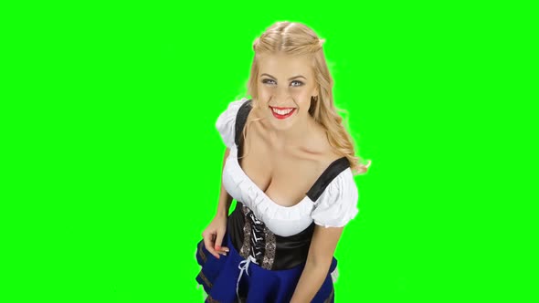 Girl in Bavarian Costume Shows Thumb and Waving. Green Screen