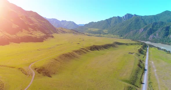 Aerial Rural Mountain Road and Meadow at Sunny Summer Morning