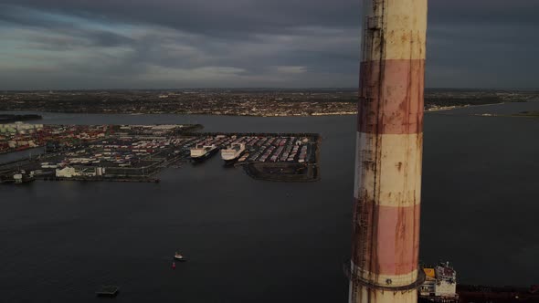 Aerial View Of Dublin Port In Dublin Ireland On A Cloudy Day With Poolbeg Chimney Reveal - drone pul