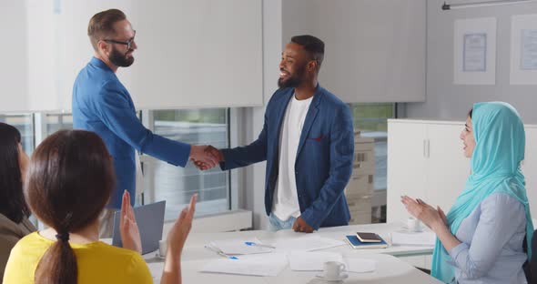 Young Modern Men in Smart Casual Wear Shaking Hands While Working in the Creative Office