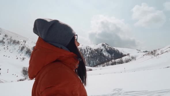 Young Asian Girl Looking at Mountains in Winter Day