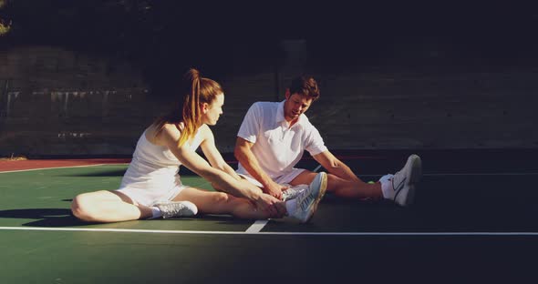 Woman and man playing tennis on a sunny day