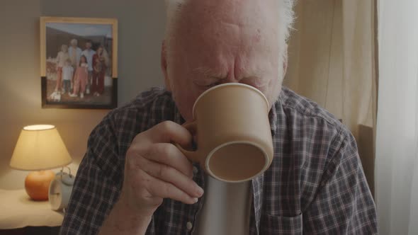 Senior Man Drinking Coffee at Home