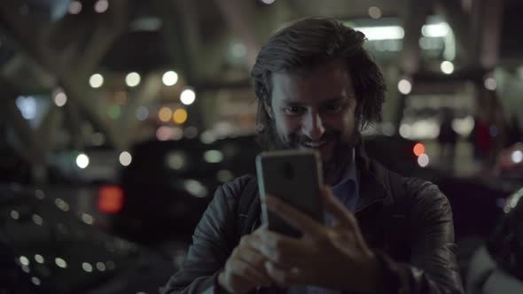 Smiling Man Waving and Making Video Call on Smartphone